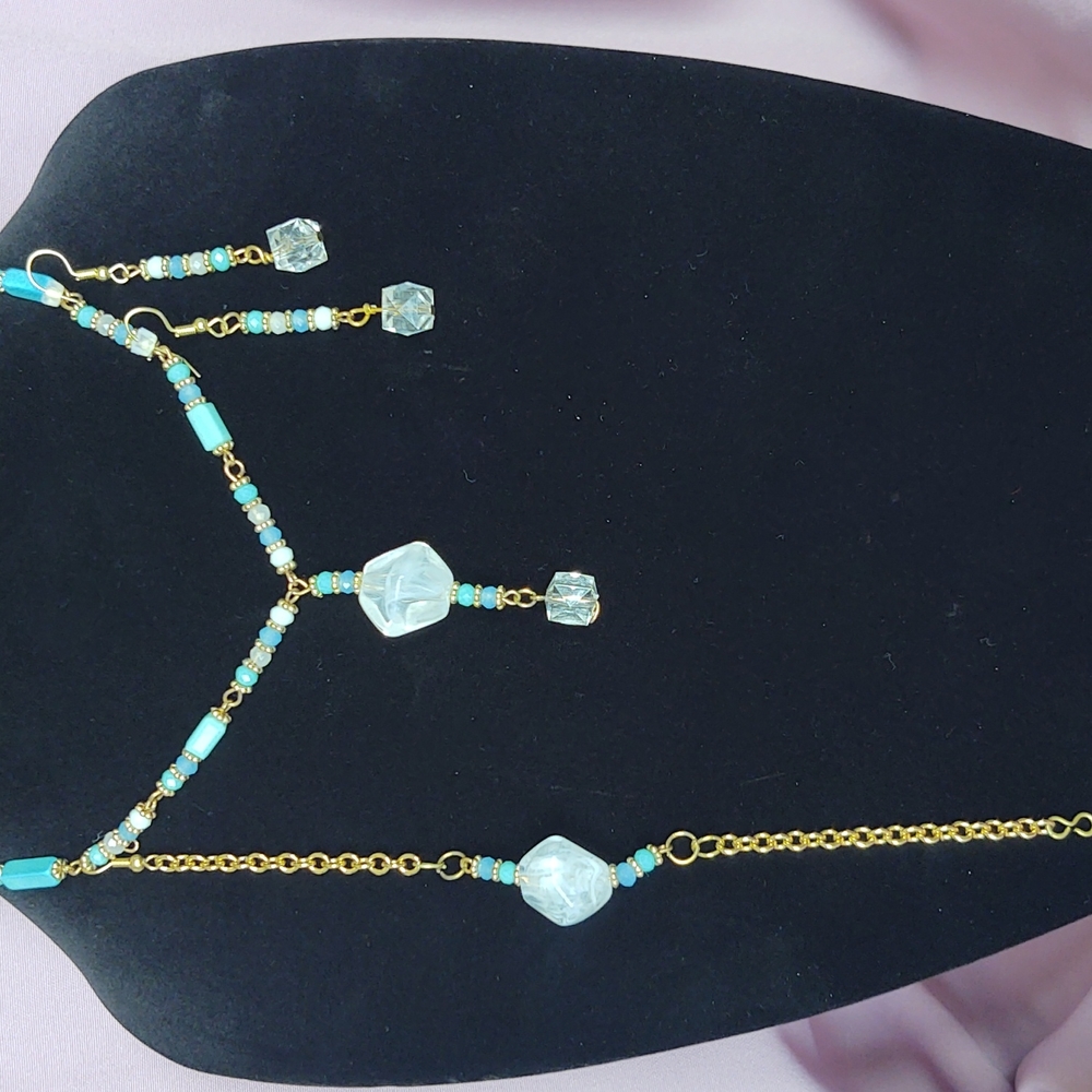 Handcrafted glass beads necklace bracelet and earring set done in a white crysta